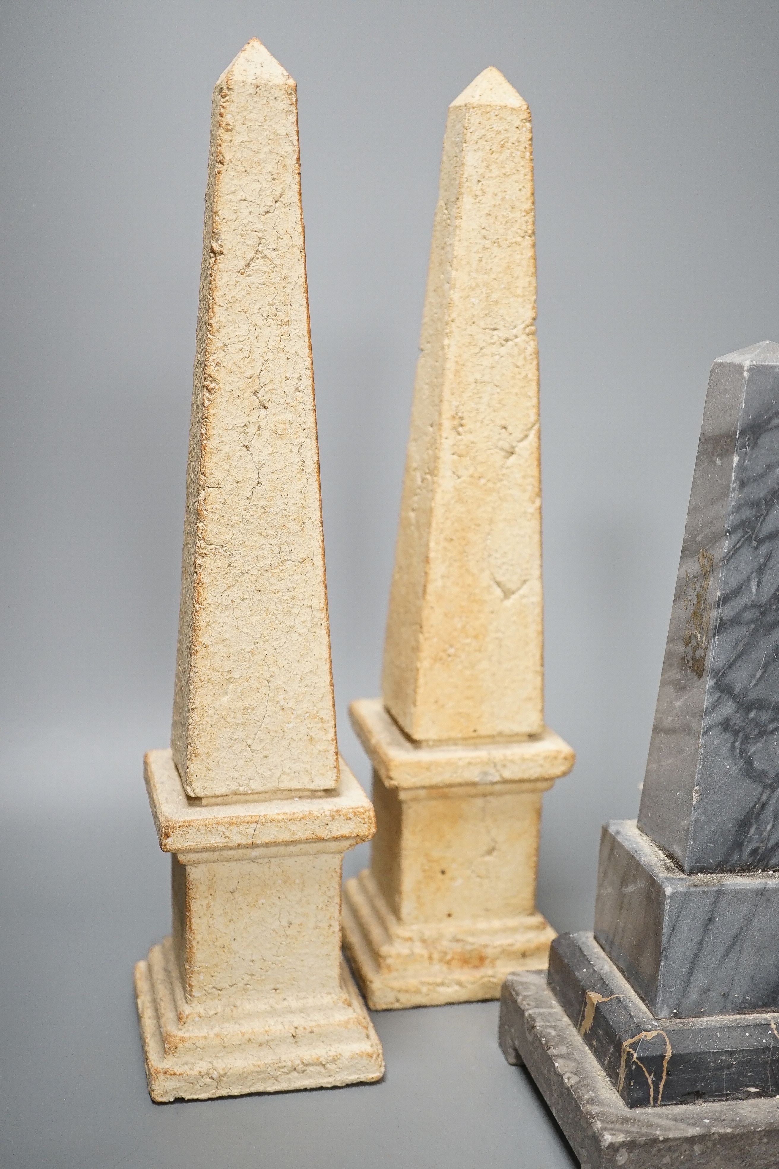 Two pairs of simulated stone obelisks, another pair and a single, tallest 33cm